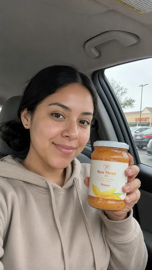 Customer smiling in the car with Fresh Sea Moss pouch