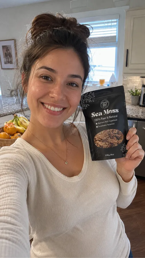 Customer selfie at home holding a Fresh Sea Moss pouch